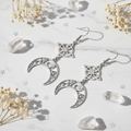 Orecchini Nodo della Strega flat lay marmo bianco