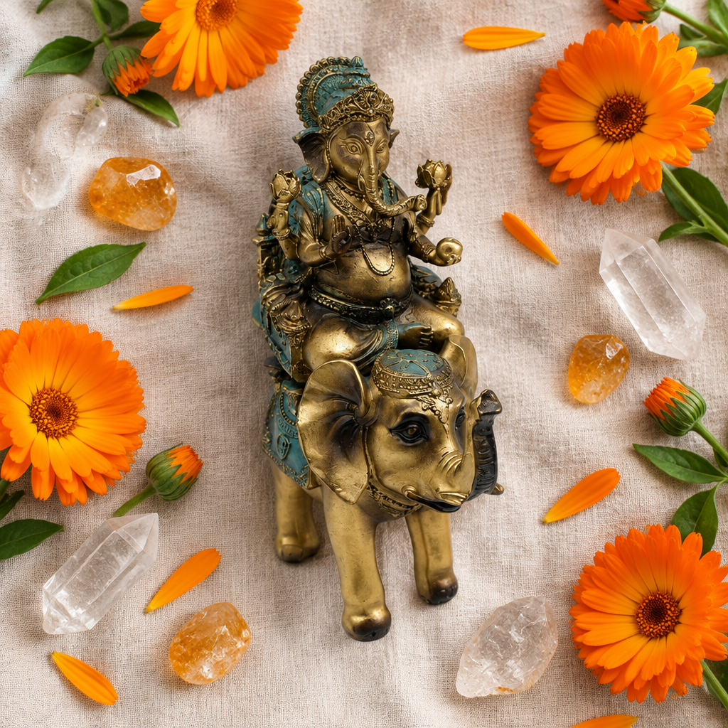 Statua di Ganesh in resina su lino con fiori arancioni e cristalli